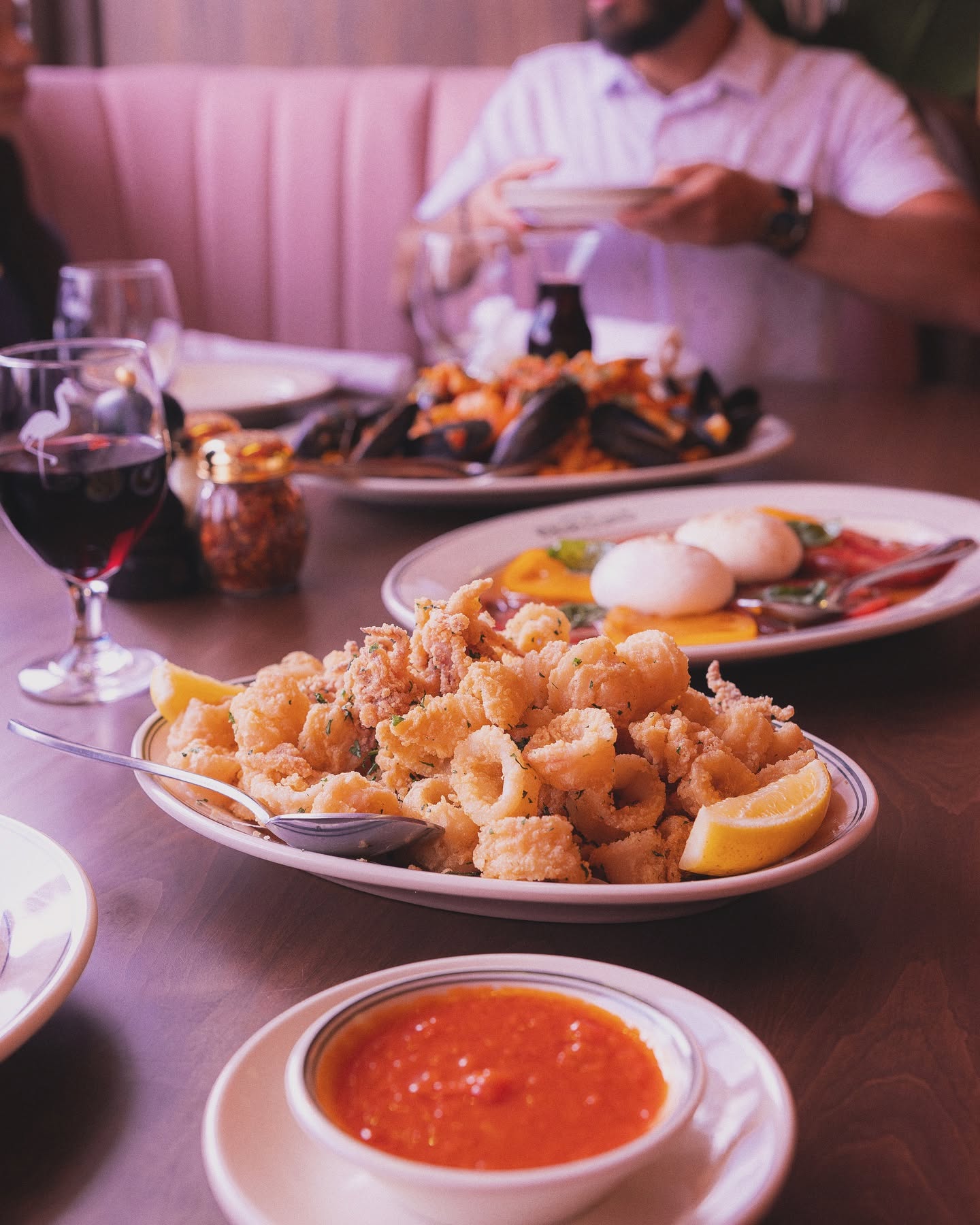 Calamari fritti with marinara and burrata on the table